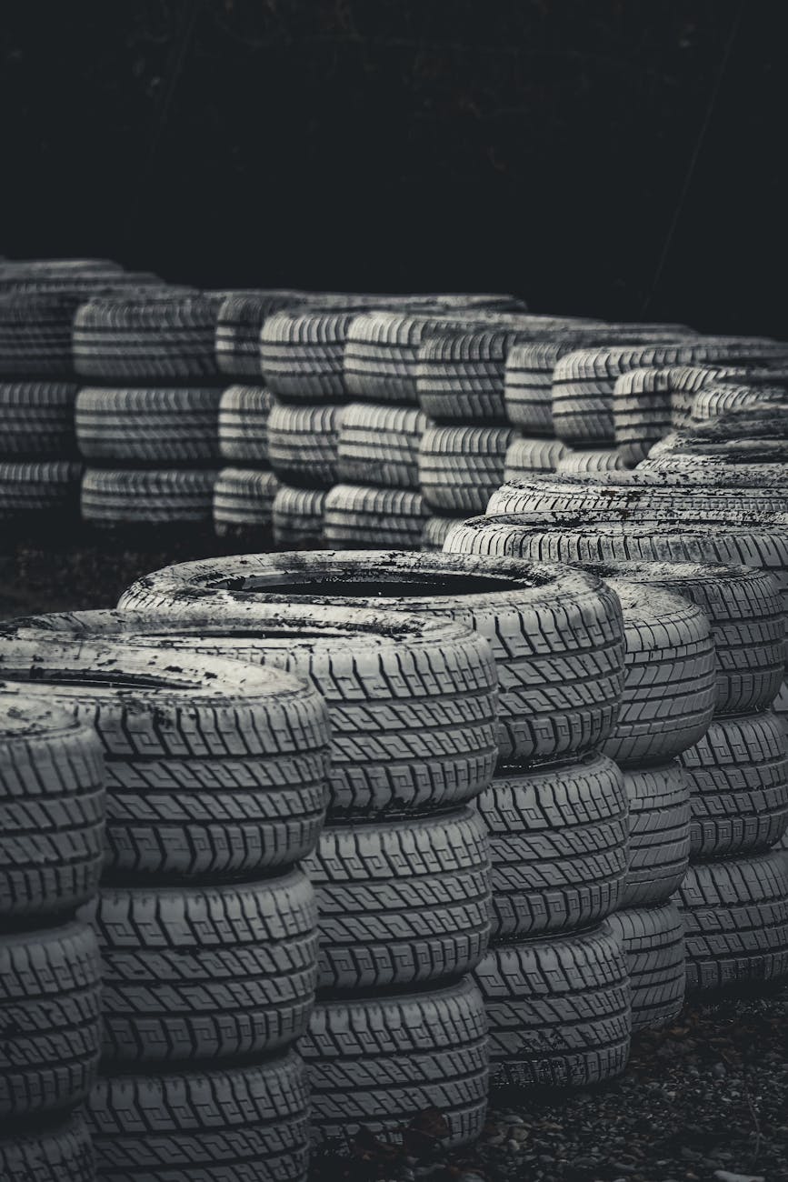 Home Vertical shot of stacked racing tires on a dark background for protection.